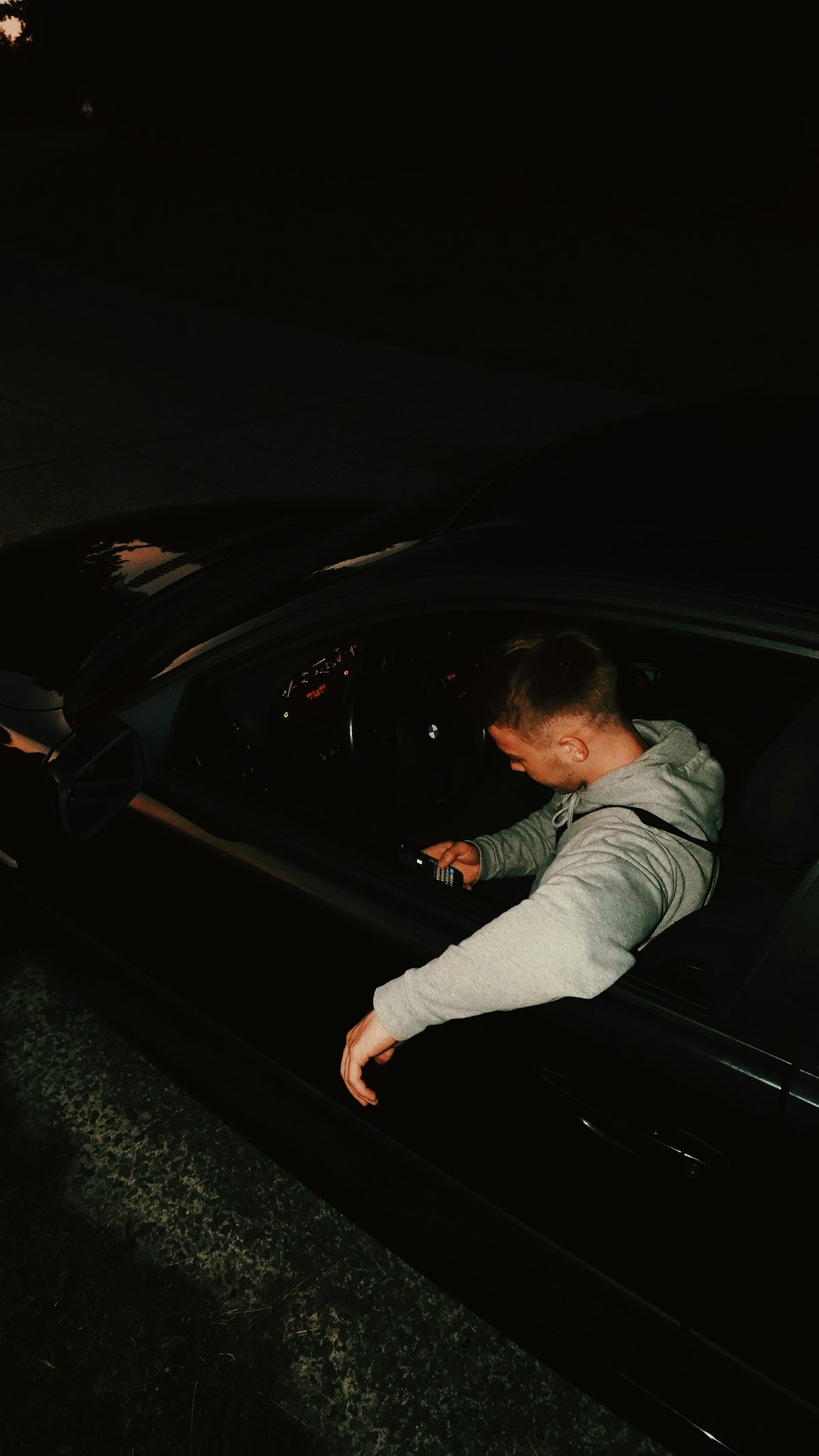 Chauffeur opening the car door at night